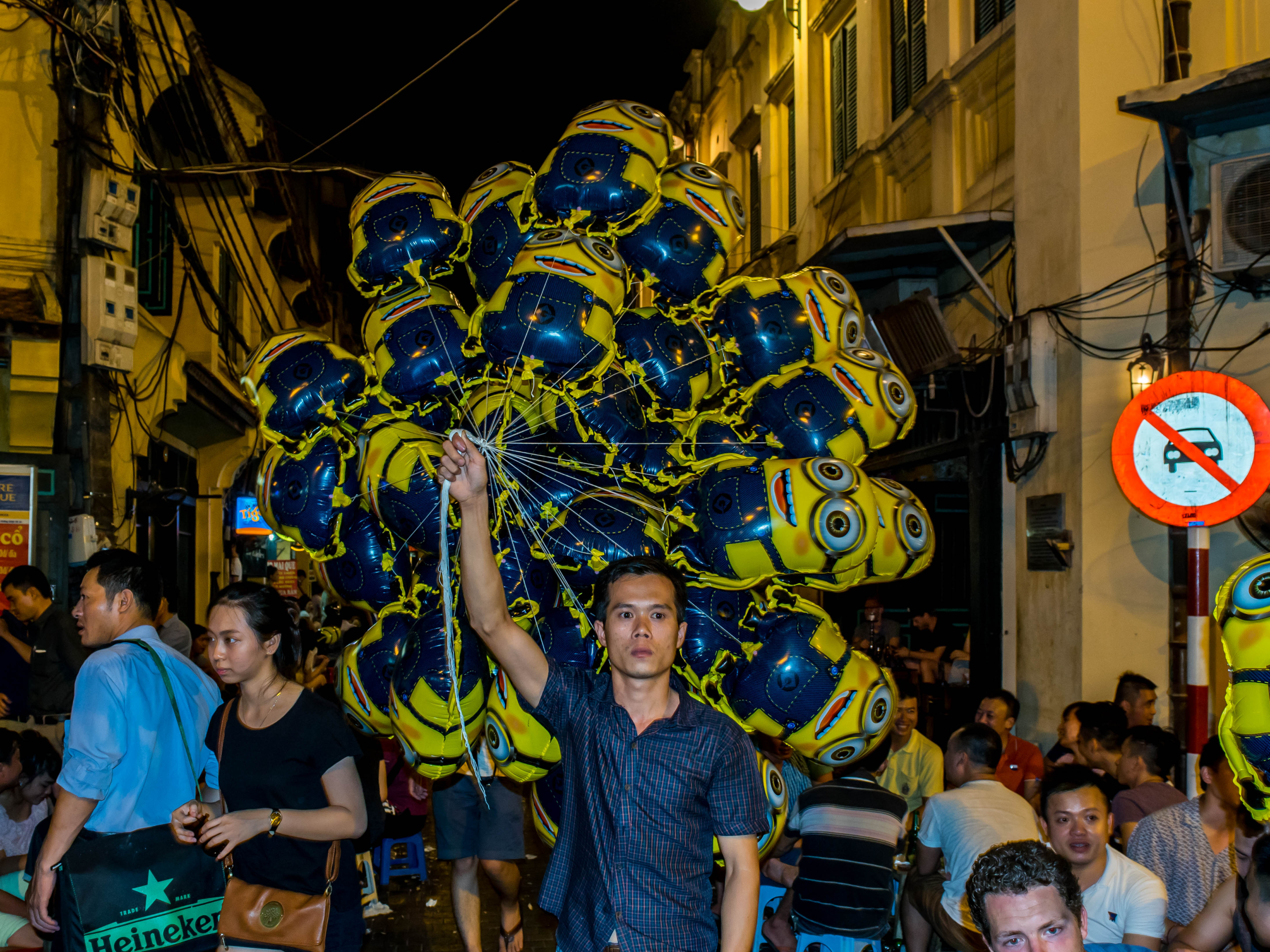 minion balloons being carried down the street of Hanoi