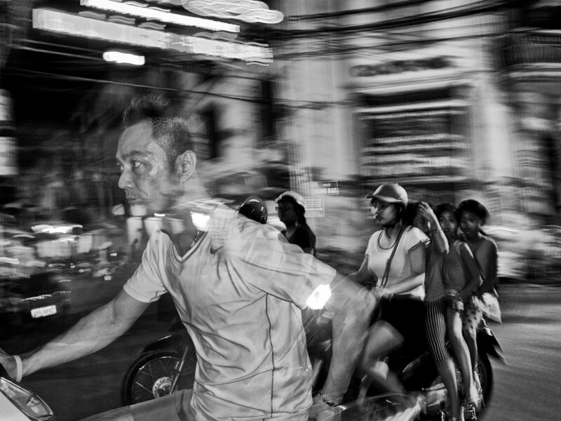 Blurred streets Person speeding through traffic in a vietnamese street