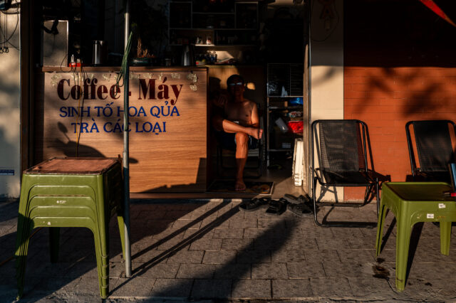 A person in vietnam sitting in the shade and the sun